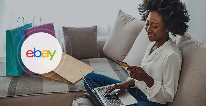 A person sitting on a couch using a laptop.