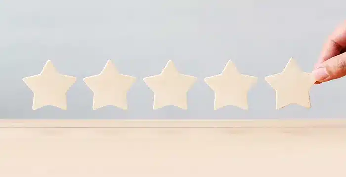 A hand holding stars made of paper.